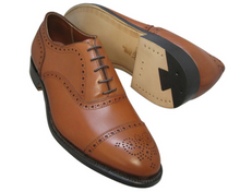 Brown leather dress shoes with black soles on a white background