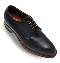 Black leather dress shoe on a white background