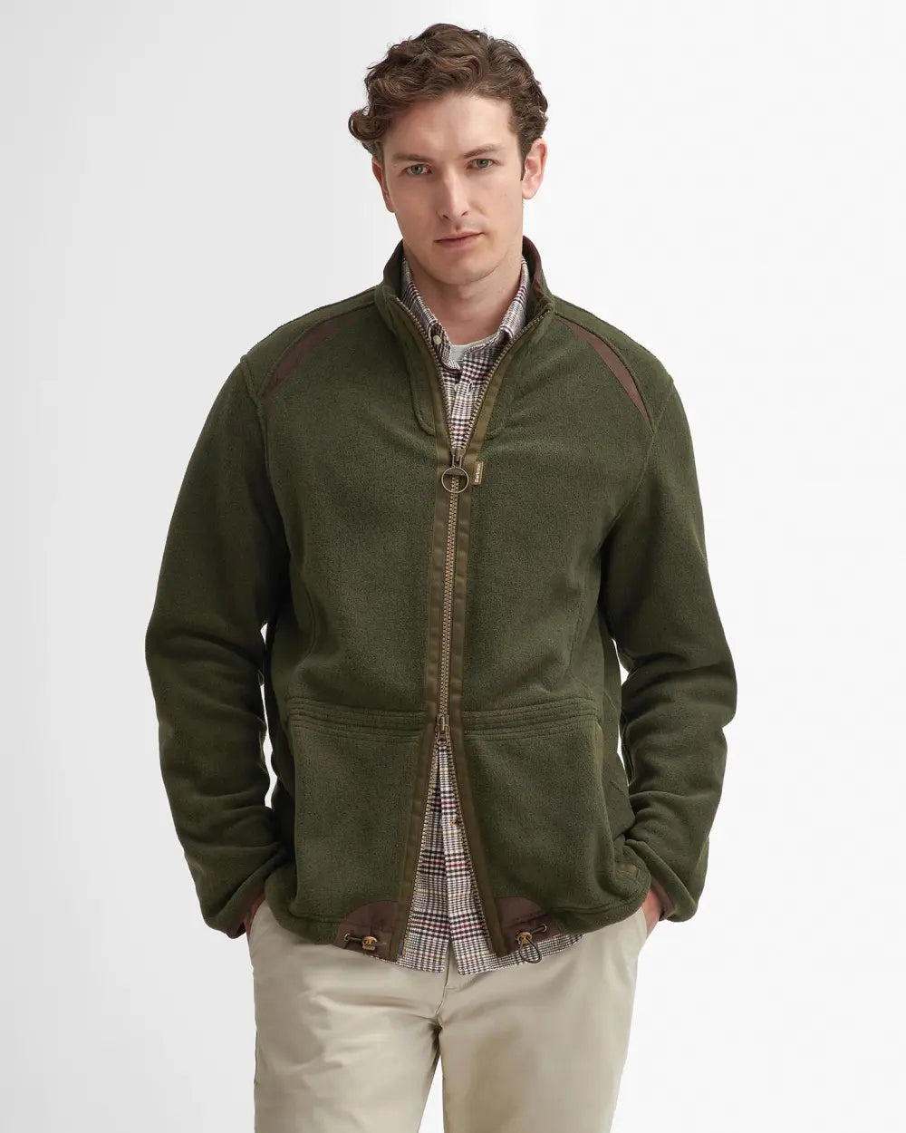 Man wearing a green jacket with brown accents on a white background