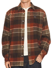 man in plaid shirt with white tee underneath
