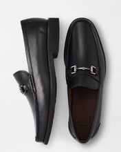 Black leather loafers with a silver buckle on a white background