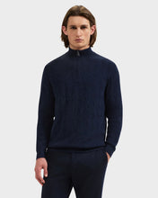 Man in Diamond pattern quarter zip in navy ribbed collar and cuffs