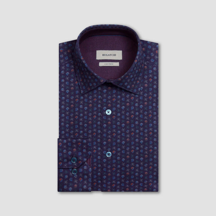 Folded patterned shirt with a visible brand label on a light gray background