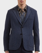 man wearing navy 2 button wool blazer with brown and navy print shirt
