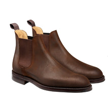 Pair of brown leather Chelsea boots on a white background