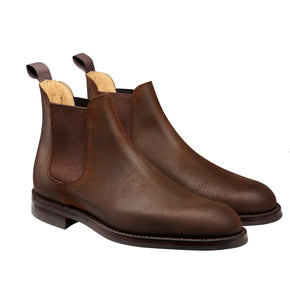 Pair of brown leather Chelsea boots on a white background