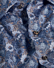 Close-up of a blue floral patterned shirt with buttons.