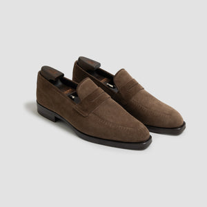 Pair of brown loafers on a light gray background