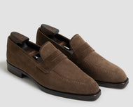 Pair of brown loafers on a light gray background