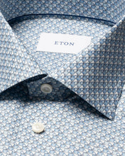 Close-up of a blue patterned shirt with 'Eton' label