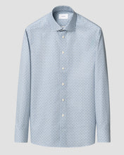 Light blue shirt with subtle pattern on a light gray background