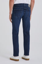 Person wearing blue jeans on a white background