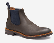 Brown leather Chelsea boot with a navy inner lining on a white background