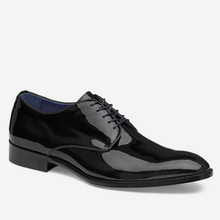 Black patent leather dress shoe on a white background