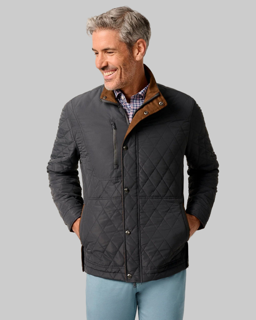 Man wearing a quilted jacket with a beige background