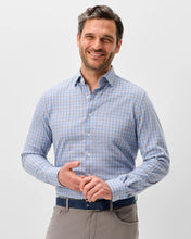 man wearing blue and brown open plaid shirt
