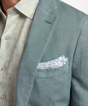 Green blazer with a patterned shirt and pocket square