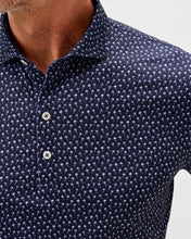 Navy blue polo shirt with white pattern on a light gray background