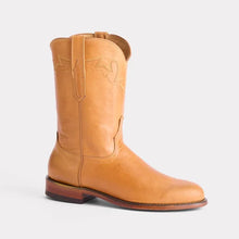 Side view of western boot with decorative stitching along top border; golden color