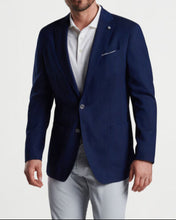 Man in navy 2-button blazer and grey pants