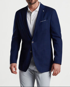 Man in navy 2-button blazer and grey pants