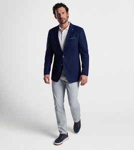 Man in navy 2-button blazer and grey pants