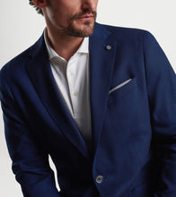 Navy single-breasted blazer over white polo