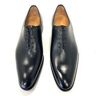 A pair of black Romano Martegani smooth plain toe Oxford shoes with lace-up closure and a wooden heel.