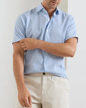 Man with sunglasses wearing short sleeve blue striped shirt