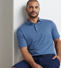 Man wearing a blue striped polo shirt against a plain background