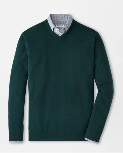 Green sweater with a white shirt underneath on a light gray background