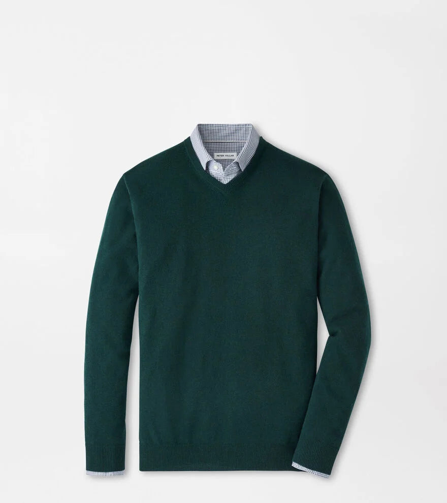 Green sweater with a white shirt underneath on a light gray background