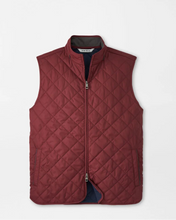 Quilted vest with diamond pattern on a light gray background