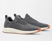 Pair of gray sneakers with white soles on a light gray background