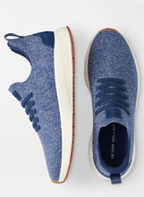 Blue sneakers with white soles on a white background