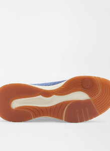 Close-up of a shoe sole with brown rubber and white midsole on a light gray background