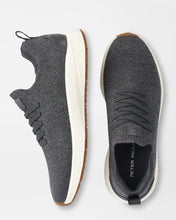 Gray sneakers with white soles on a light gray background