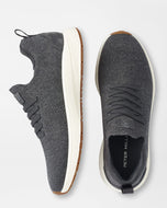 Gray sneakers with white soles on a light gray background