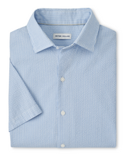 Folded blue and white striped dress shirt on a white background