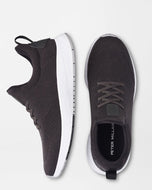A pair of charcoal-colored Peter Millar Tellustride sneakers with lace-up closure, shown from the side and the sole.