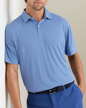Man wearing a blue striped polo shirt against a plain background