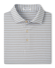 Striped polo shirt with Peter Millar label on a white background