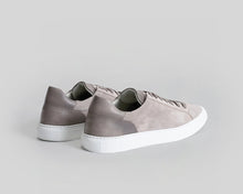 Pair of gray sneakers on a light gray background