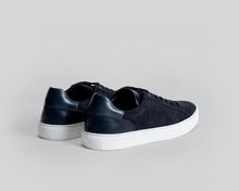 Pair of black sneakers on a light gray background