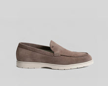 Beige loafer shoe with tassels on a white background