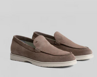 Pair of brown loafers on a light gray background