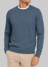 Man wearing Turtleson's blue crew neck cashmere sweater with brown rim around collar
