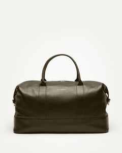 Green leather duffel bag on a white background