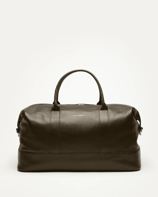 Green leather duffel bag on a white background