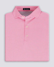 Folded pink checkered polo shirt with a brand label on a light gray background